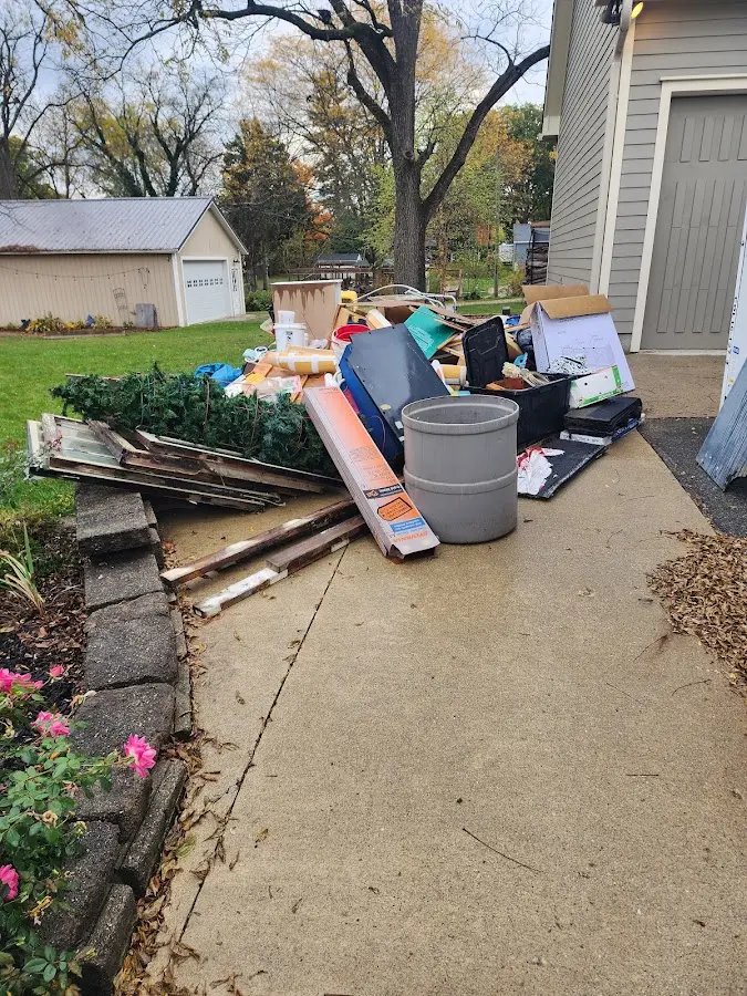 Dumpster being loaded with debris for Estate Cleanout Dumpster Rental in Brattleboro